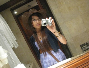Highschooler Ari taking a mirror selfie with the silver Olympus.