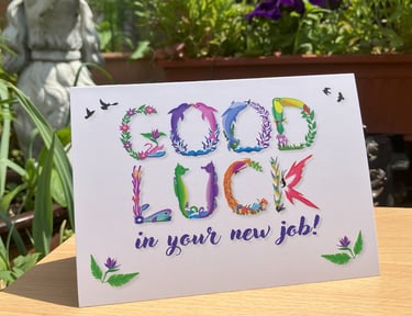 A greeting card with the words Good Luck in your new job printed in tropical exotic word art