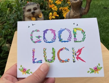 A greeting card with the words Good Luck printed in tropical exotic word art