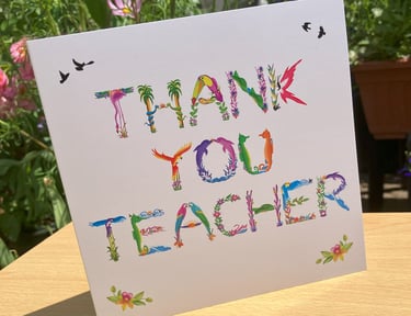 A greeting card with the words Thank You Teacher printed in tropical exotic word art