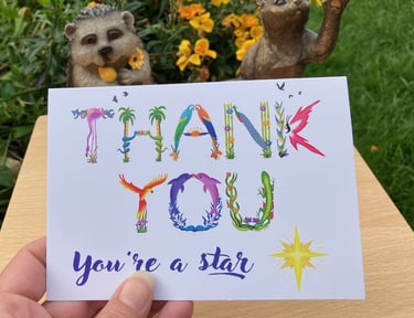A greeting card with the words Thank You you're a star printed in tropical exotic word art