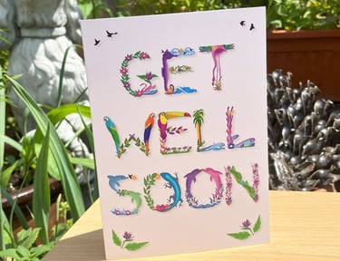 A greeting card with the words Get Well Soon printed in tropical exotic word art