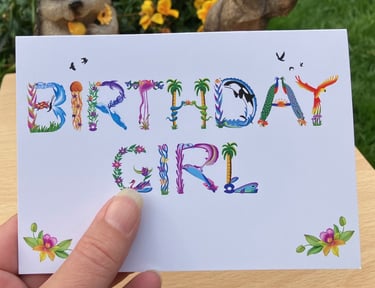 A greeting card with the words Birthday Girl printed in tropical exotic word art