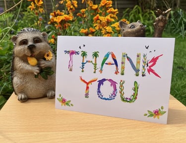 A greeting card with the words Thank You printed in tropical exotic word art