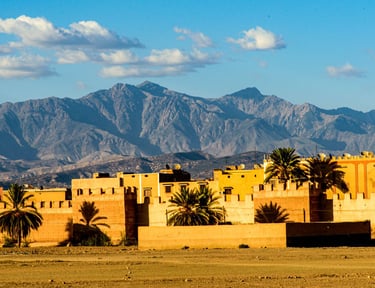 a large building with a mountain in the background