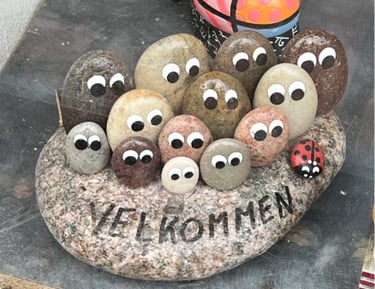 pebble art - painting eyes on pebbles and gluing them together to create art piece