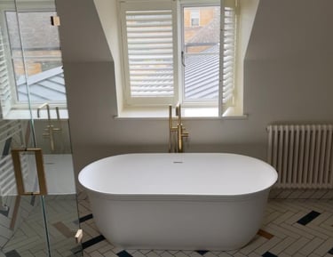 a bathtub with a large tub in the middle of a bathroom in pershore