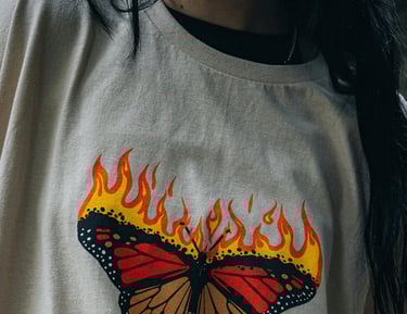 a woman with a butterfly butterfly on a white shirt