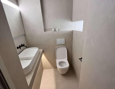 a bathroom with a toilet and a sink fitted by pbp services in droitwich