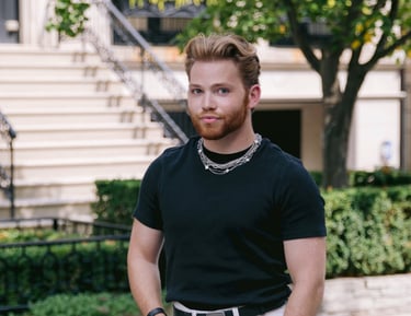 a man in a black shirt and white pants