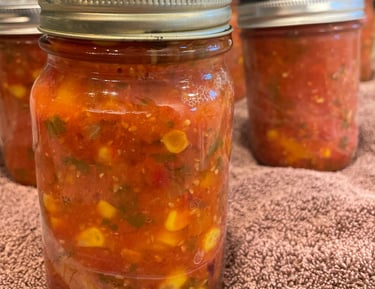 Canning the harvest - cherry tomato and corn salsa.