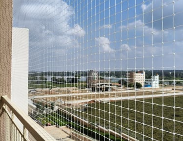 Happy family enjoying their balcony safely protected by a net.