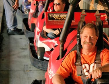 man posing in outdoor go kart line