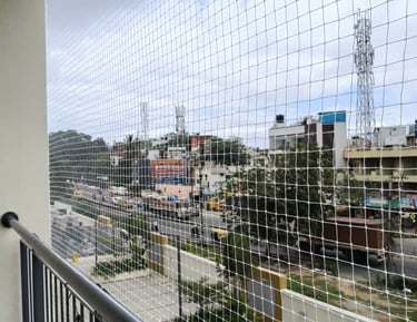 Completed balcony safety net installed, blending seamlessly with building facade.