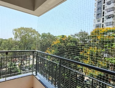 Wide shot of a commercial building in Koyambedu secured with anti-pigeon nets.