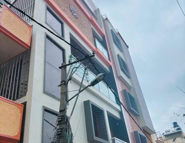 Technician carefully installing anti-pigeon netting on a window frame.
