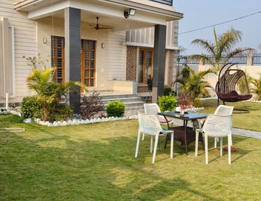 Modern PG with a green lawn, outdoor patio furniture, and a hanging swing chair.