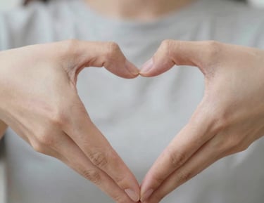 man doing heart hand sign