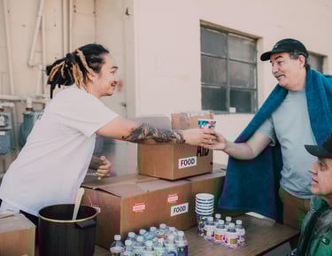 Volunteer distributing food and beverages to the community