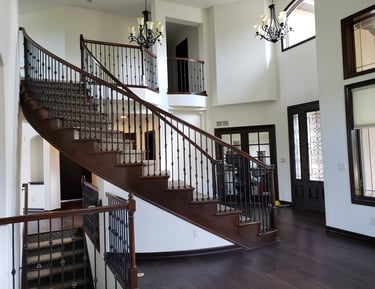 a staircase leading to a second story balcony