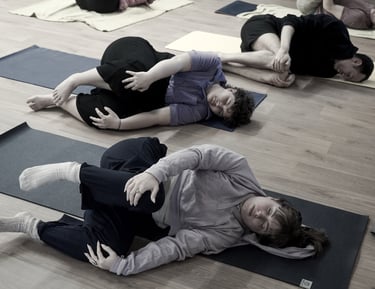 People rolling on the floor in a Feldenkrais workshop