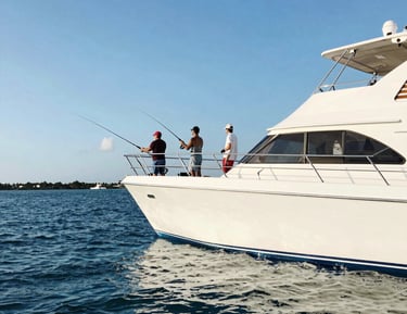 Fisherman casting a line from a boat during a peaceful sport fishing trip at sunrise.