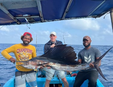 a man holding a sailfish on a boat