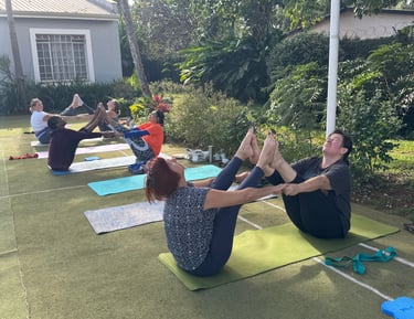 Participants are practicing partner yoga for deep stretching. 
