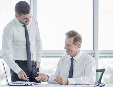Consultant and client reviewing documents in an office Saudi Food Registration