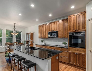 a kitchen with a large island and a clock on the wall