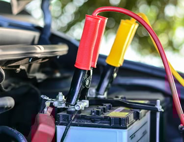 Jumper cables attached to a car battery