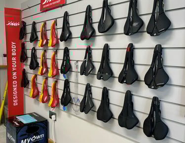 A wall full of bicycle test saddles