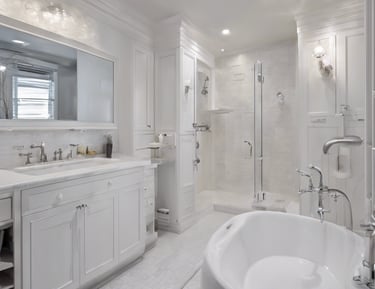 An outdoor area features a modern heat pump unit positioned against a white wall. The setting is minimalist, with a stone and pebble landscape surrounding the unit. Two black planters contain manicured green shrubs, adding a touch of nature to the space. A reflective silver garden sphere provides a decorative element amidst the functional design.