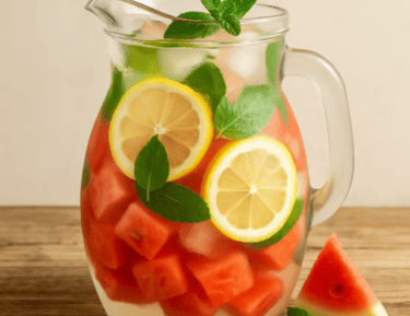 a pitcher of watermelon with slices of watermelon