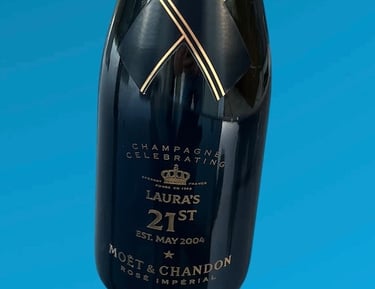a bottle of champagne with bespok engraving for 21st