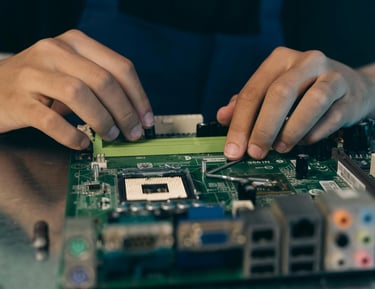 a person is holding a piece of a motherboard