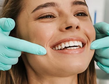 Smiling woman receiving a professional dental checkup for teeth whitening and oral health.