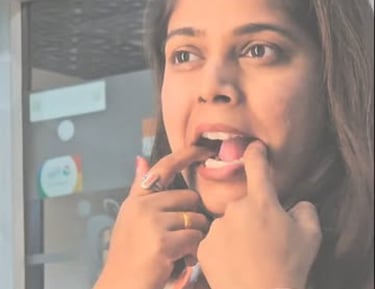 A woman demonstrating how to whistle loudly using her fingers inside her mouth.