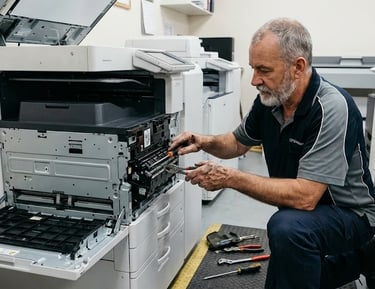 a man in a black shirt is working on a printer
