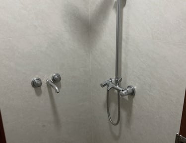 Workers assembling hotel room equipment in a factory setting with precision.