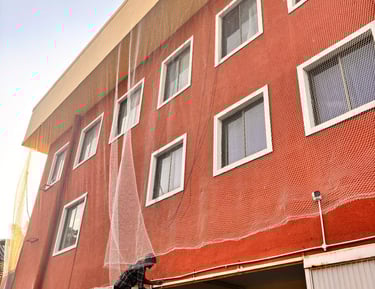 Completed balcony safety net system blending seamlessly with the building structure.
