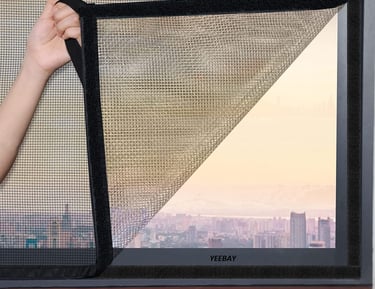Installation team fitting a velcro type mosquito net on a residential window.
