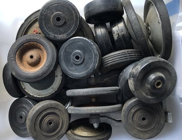 A bin full of tires from children's toys inside an assemblage artist's studio.