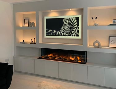 Modern media wall featuring cosy lighting and bespoke shelves