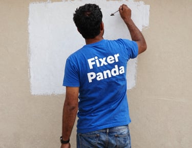 A freshly painted wall in vibrant blue and orange tones reflecting Fixer Panda’s brand colors.