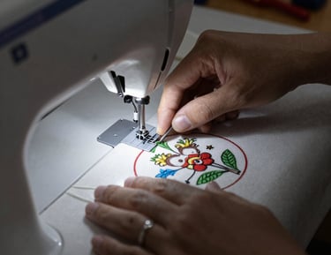 A father and son sewing a quilt side by side, smiling and focused.