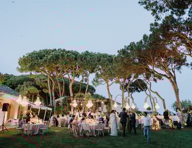 Evening wedding reception at Villa El Rincon with chandeliers and garden dining