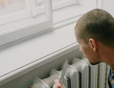 a man in a blue shirt is holding a knife and a knife in his hand