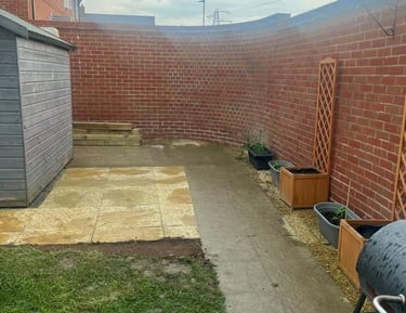 a backyard patio with garden wall brickwork