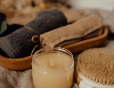 a brush, cloth and candle on a table